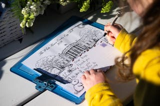 A child writes a letter to American troops at the White House Easter Egg Roll